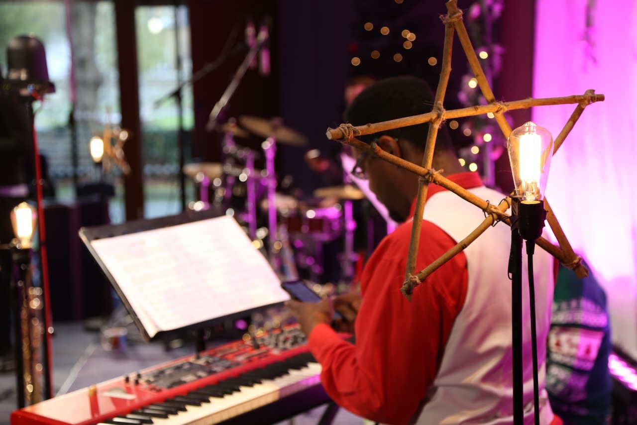 Keyboard setup on stage at The Roots of Jazz with a close up of a Christmas decoration